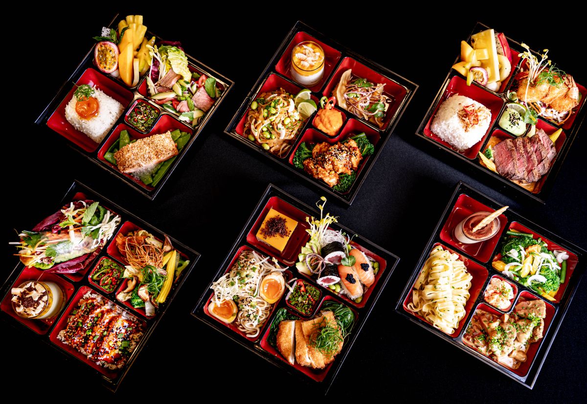 Bento-box lunch, top-down view on a black background